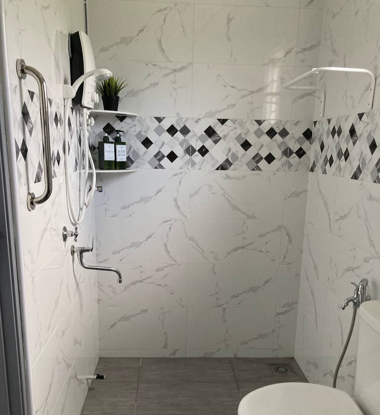 Second bathroom with black and white diamond mosaic tile shower
