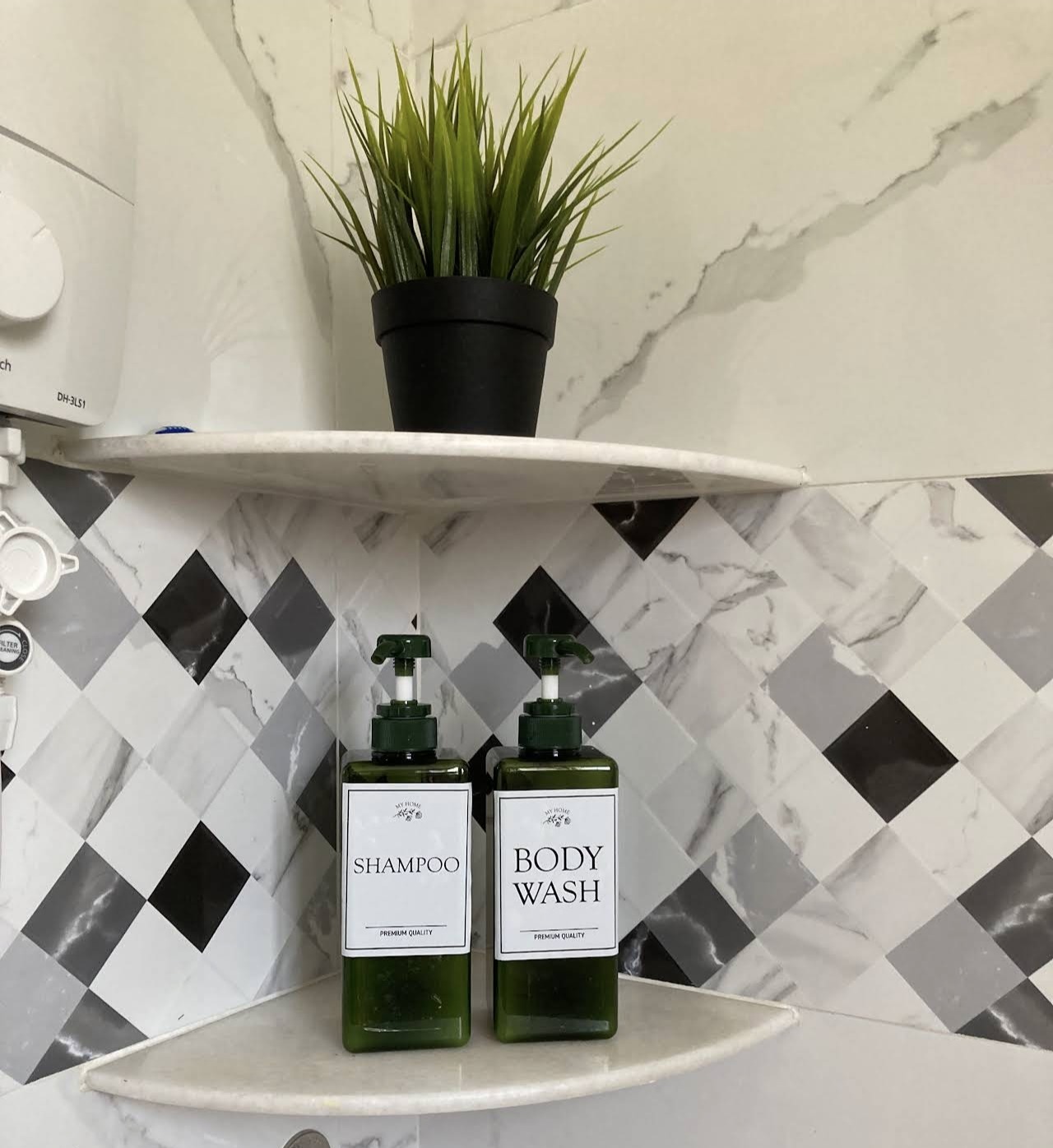 Shampoo and body wash bottles provided on a bathroom shelf