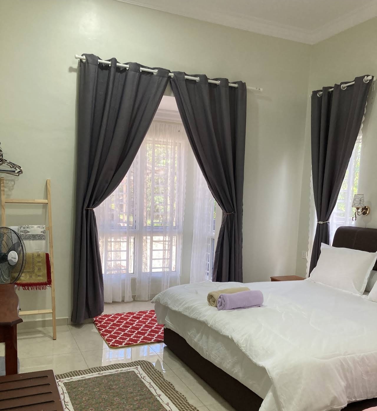 Master bedroom, alternate angle showing the standing fan and storage ladder
