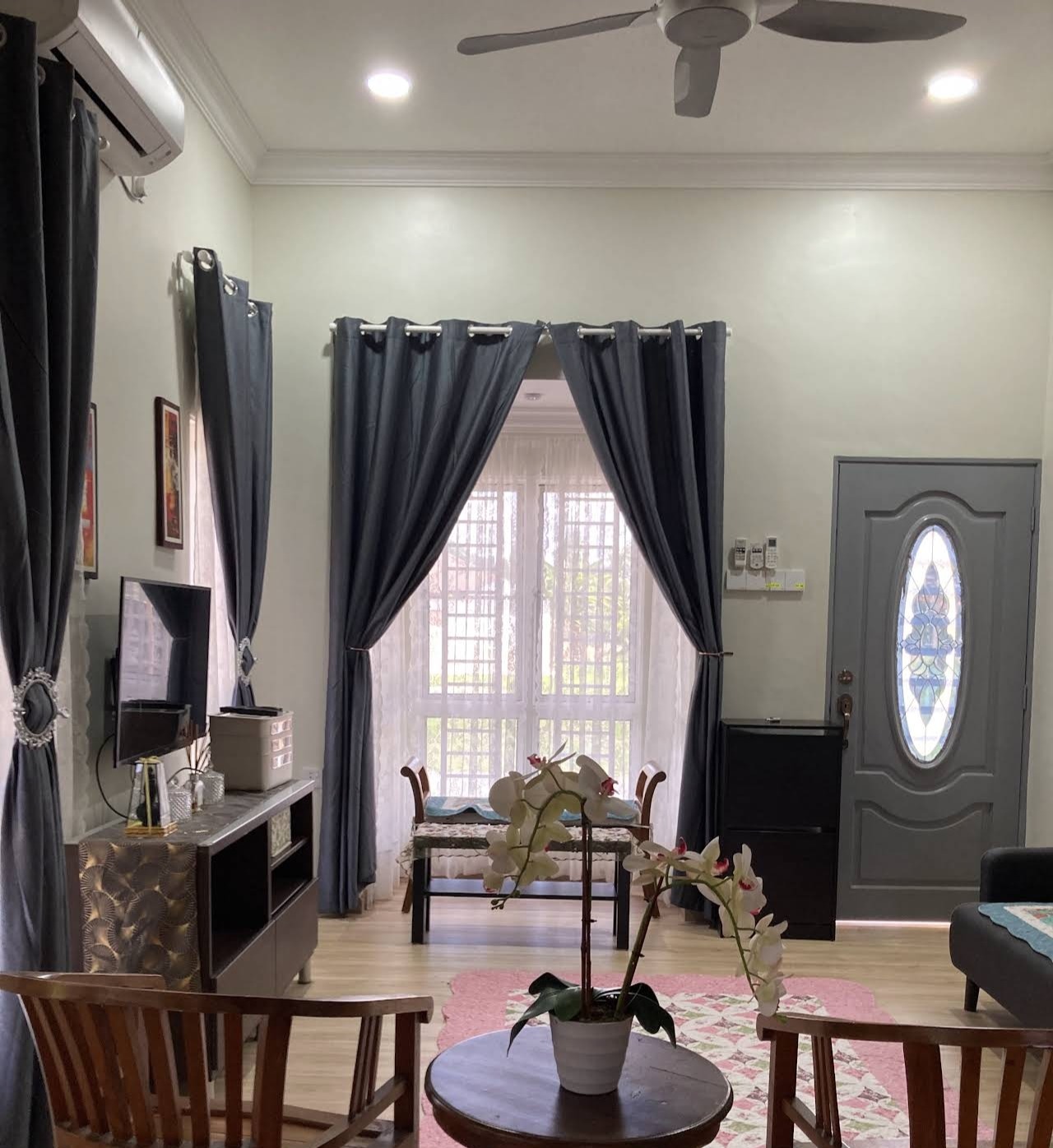 Living room view toward the front door with air-conditioning unit