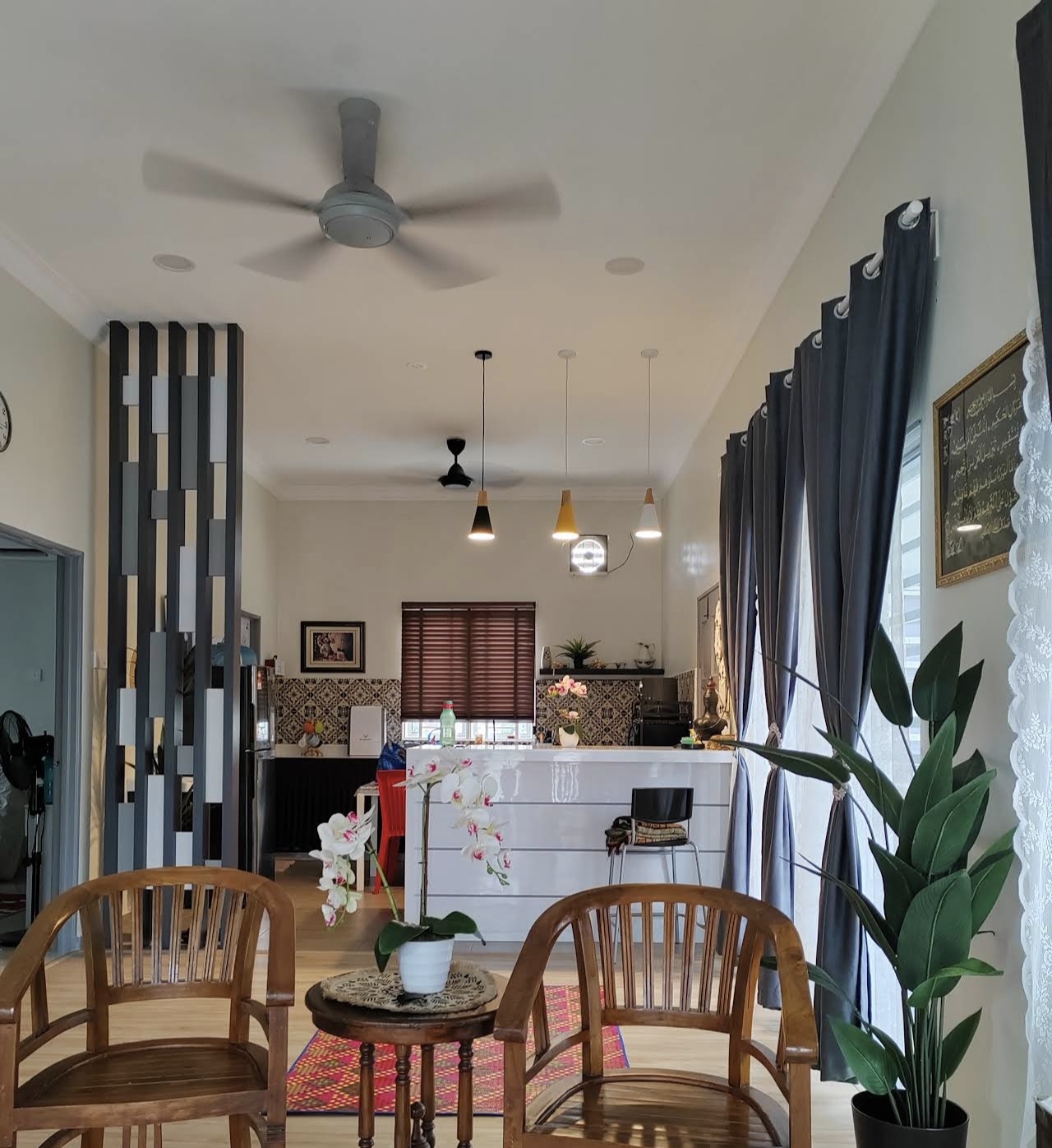 Living room seating area with kitchen bar in the background